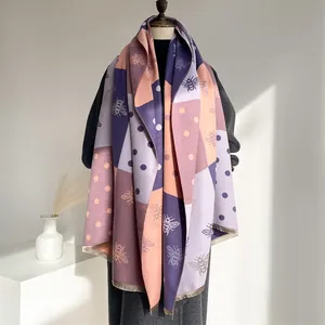 Close-up of winter thick cashmere feel scarf featuring purple patchwork and bee patterns