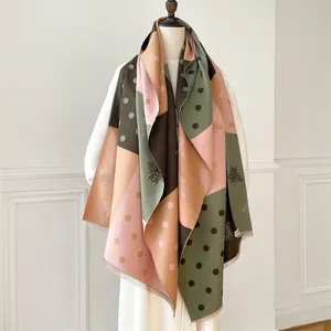 Detailed shot of multi-color block scarf with bee print, polka dots and fringe edges