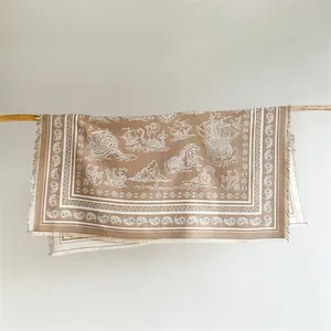 Detail of bohemian brown scarf with white nautical prints, ship motifs and fringed edges