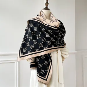Detail of clover pattern on thick winter shawl scarf with elegant tassel fringe edges