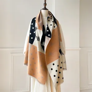 Detail of cashmere-like shawl with honey bee texture and tri-color block pattern