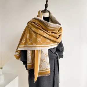Close-up of ginger yellow clover pattern scarf with fringe on a long wool coat