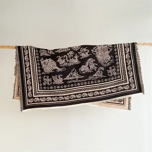 Close-up of maritime nautical pattern on a thick fringed shawl with vintage ship motifs