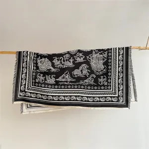 Macro detail of nautical black and white paisley shawl with ship and sea monster patterns