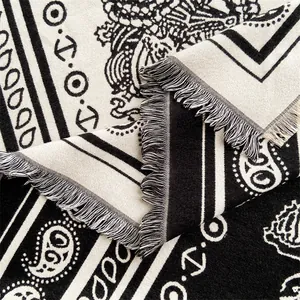 Detail of bohemian paisley shawl with fringe trim and soft thick woven texture