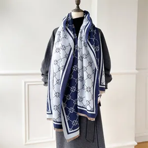 Close-up of navy blue and grey reversible cashmere-feel scarf with clover floral patterns