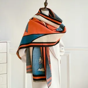 Detail of color-block scarf with artistic landscape pattern and fringe on beige coat