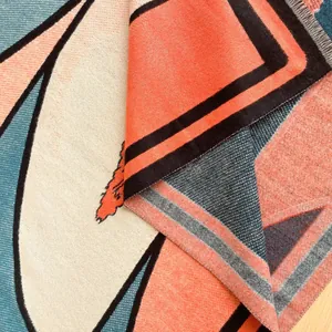 Close-up of geometric cashmere-like scarf with thick knitting texture and fringe tassels