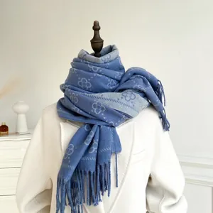 Detail of navy blue and grey pashmina scarf with floral pattern and soft fringe edges