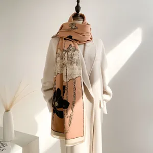 Close-up of elegant lotus print shawl scarf with fine tassel fringe and warm texture