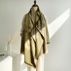 Detailed view of elegant lotus flower print on soft cashmere-like olive green scarf with fringes