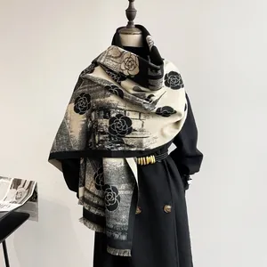 Detail of winter cashmere scarf featuring vintage camellia patterns and soft tassels