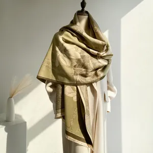 Detailed view of winter cashmere-feel scarf with vintage lotus patterns and tassels