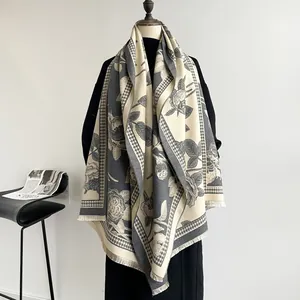 Detail of elegant grey houndstooth scarf with rose pattern and soft fringe tassels