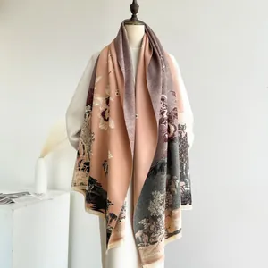Detail of pink cashmere-like shawl featuring traditional landscape jacquard and soft fringe