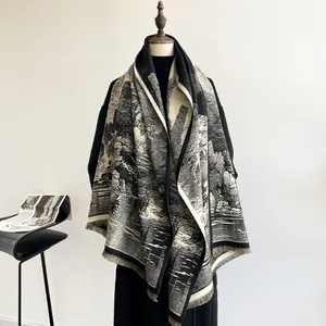 Detail of landscape toile de jouy pattern and fine fringe trim on monochrome shawl