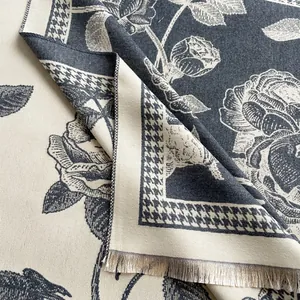 Close-up of elegant floral jacquard pattern and fine tassel fringe on a thick shawl