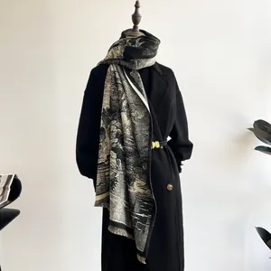 Detail of vintage landscape print scarf with fringe edge on a black coat model