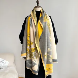 Detailed texture of thick floral pashmina scarf with elegant fringe and color block borders