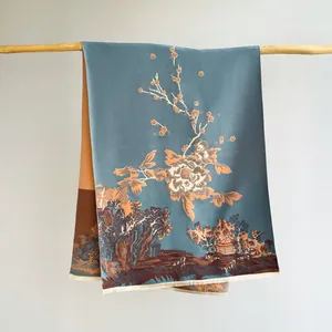 Detailed view of cashmere-feel scarf featuring vintage orange peonies and landscape patterns