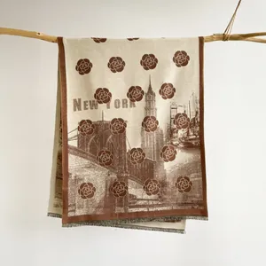 Detail of cashmere-like scarf showing vintage camellia pattern and New York skyline print
