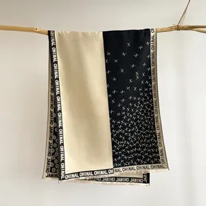 Detail of camellia pattern scarf showing fine fringe edges and contrast color stitching