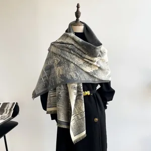 Detail of gray and beige jacquard pashmina shawl with tassel edge and scenic pattern