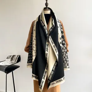 Detail of camellia flower pattern and fringe on black and white cashmere scarf