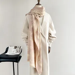 Detail of pink houndstooth floral scarf with fringe on cream coat for women
