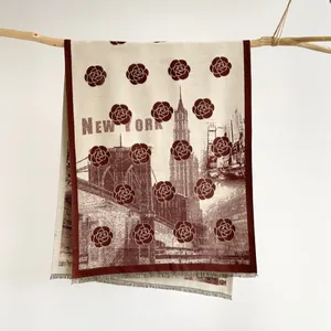 Macro view of cashmere-feel scarf with New York landmarks and camellia jacquard patterns