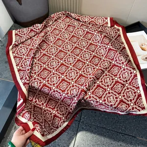 Close-up of red silk scarf featuring auspicious Fu characters and traditional patterns
