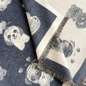 Detailed close-up showing reversible cartoon dog jacquard weave and soft fringe tassels