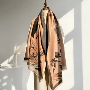 Detail of floral cashmere-like shawl featuring retro plant prints and fine fringe tassels