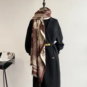 Detailed shot of retro burgundy floral scarf with tassel edges and castle patterns
