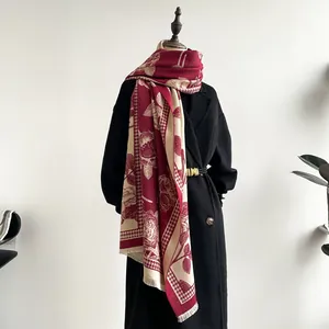 Detail of dark red floral jacquard scarf with houndstooth pattern and short fringes
