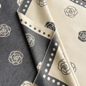 Detail of camellia jacquard knit pattern on vintage grey and beige winter shawl