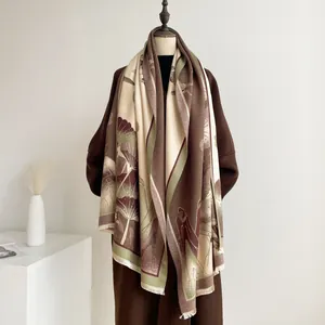 Detail of jacquard scarf with lotus pattern and tassels on a wool coat