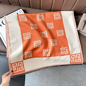 Detail of orange and beige jacquard scarf with geometric 4G logo pattern and fringe