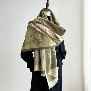 Detail of vintage floral pattern and soft fringe on thick green pashmina shawl