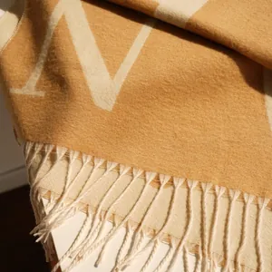 Thick faux cashmere scarf with yellow H letter jacquard pattern and fringe tassels