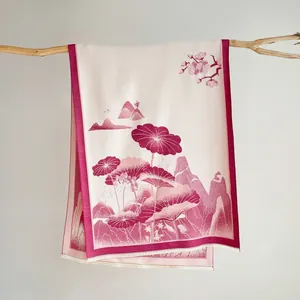 Detailed close-up of floral jacquard scarf with lotus pattern and delicate tassel edge