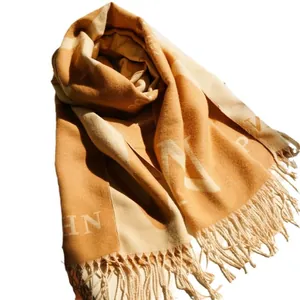 Thick cashmere-like scarf with ginger and cream color block and fringe tassels