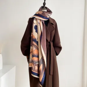 Close-up detail of thickened jacquard scarf featuring artistic ginkgo leaf patterns and tassels