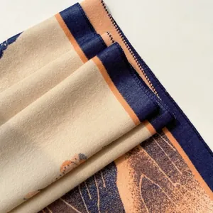 Detailed close-up of retro jacquard scarf showing orange and navy geometric fabric texture