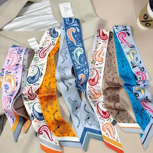 Detail of elegant paisley and leopard print silk-like twilly scarves on a suit