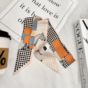 Macro detail of twilly scarf with horse patterns on fashion magazines and coffee background