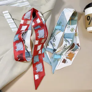 Close-up of printed twilly silk scarves laid on a beige blazer with fashion patterns