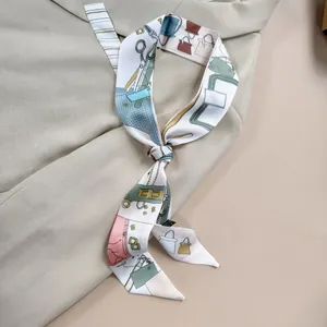 Close-up of silk twilly scarf with fashion print tied on a beige suit blazer