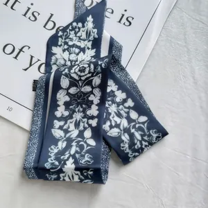 Macro shot of navy and white floral silk scarf texture on an elegant magazine background