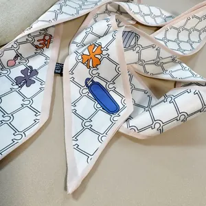 Close-up of white silk twilly scarf with chain pattern and orange number 31 on leather